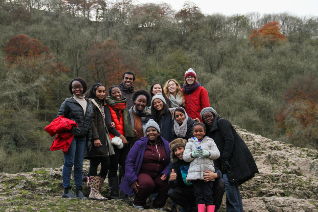 Young people smiling on a rock